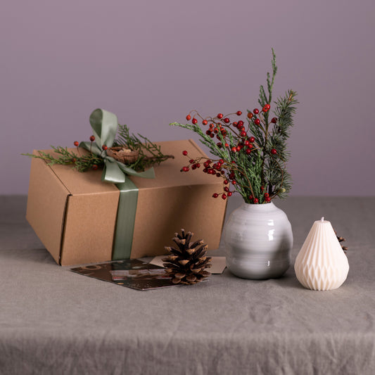 Handmade vase with flowers and candle as part of corporate gift
